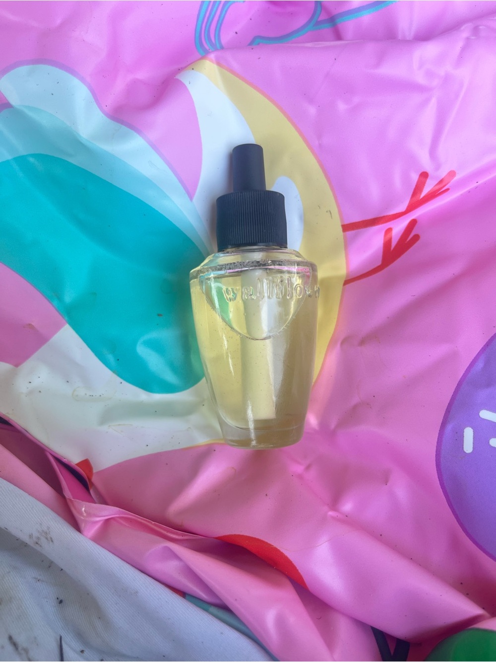Wallflower Clear Glass Dropper Bottle with Black Cap on Pink Teal Backdrop